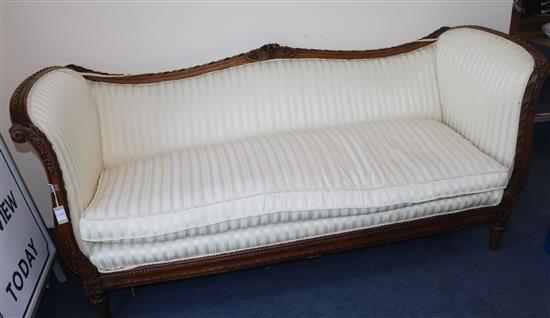 A Louis XVI style walnut serpentine settee, W.7ft 2in. D.2ft 10in. H.3ft 2in.